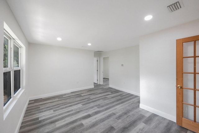 spare room featuring wood-type flooring