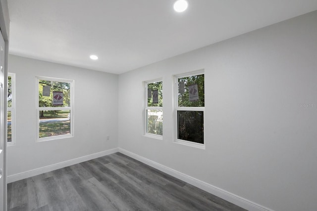 unfurnished room featuring dark wood-type flooring