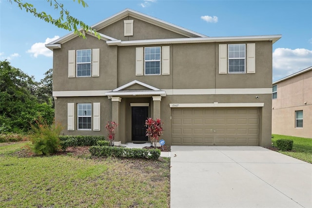 view of front of property featuring a front lawn and a garage