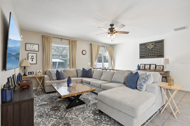 living room featuring light tile patterned floors, ceiling fan, and visible vents