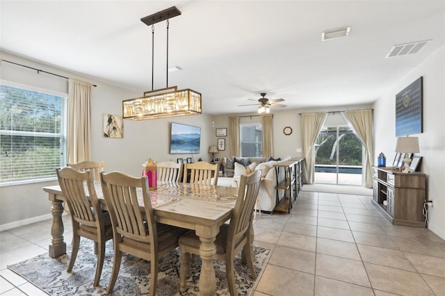 dining area with light tile patterned floors, ceiling fan, plenty of natural light, and visible vents