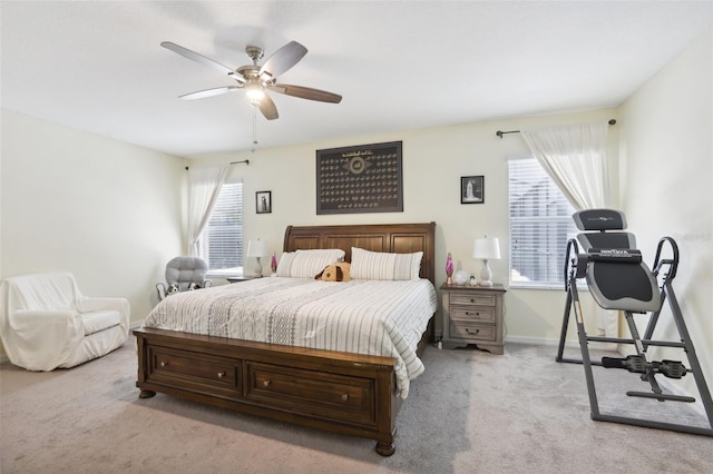 bedroom with a ceiling fan, light colored carpet, and baseboards