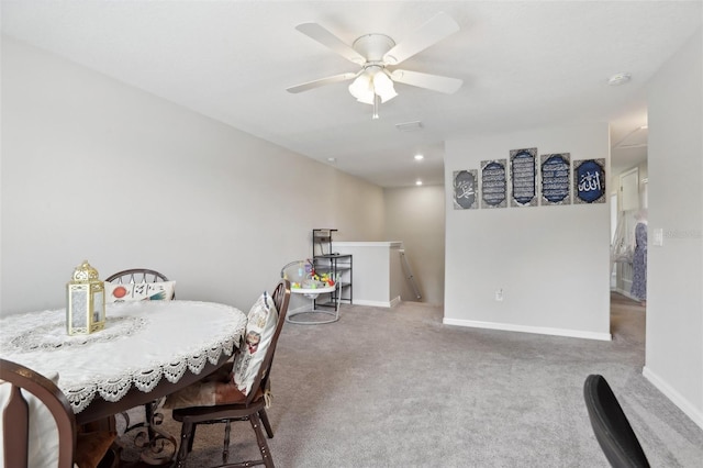 dining area with carpet flooring and ceiling fan