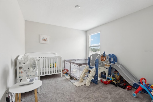 carpeted bedroom with a nursery area