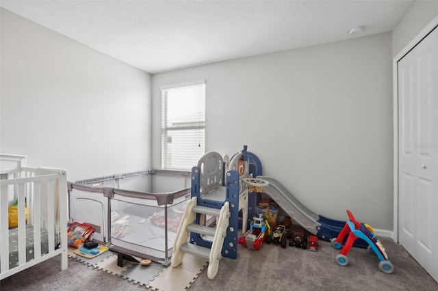 bedroom with carpet and a crib