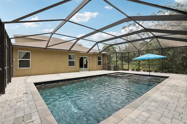 view of swimming pool featuring a lanai and a patio