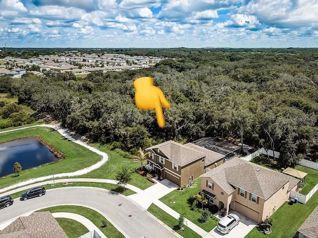 drone / aerial view with a residential view and a wooded view