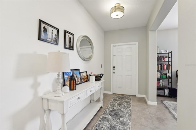 entrance foyer featuring light tile patterned flooring and baseboards