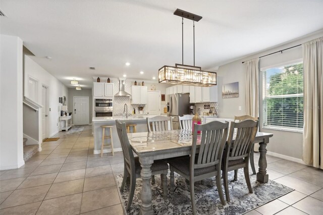 dining room with stairs, recessed lighting, light tile patterned flooring, and baseboards