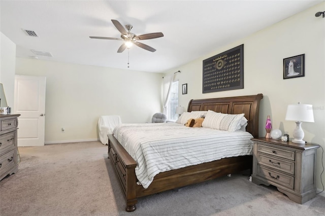 bedroom with baseboards, a ceiling fan, visible vents, and light colored carpet