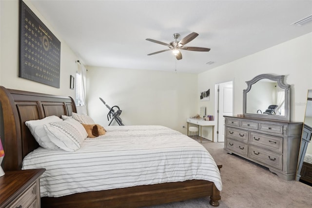 carpeted bedroom with a ceiling fan and visible vents