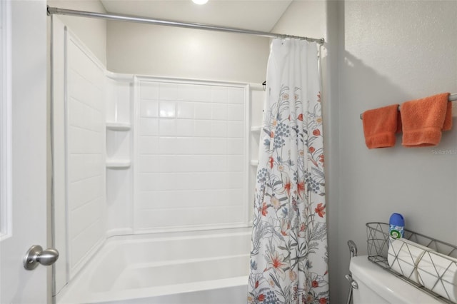 bathroom with toilet and shower / bath combo