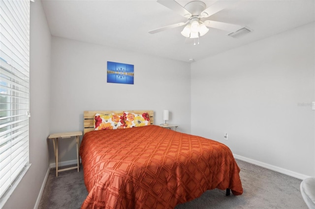 carpeted bedroom featuring a ceiling fan, visible vents, and baseboards