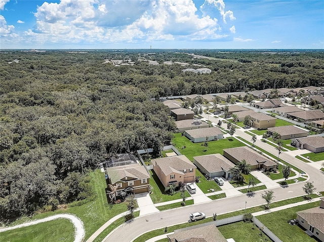 drone / aerial view with a forest view and a residential view