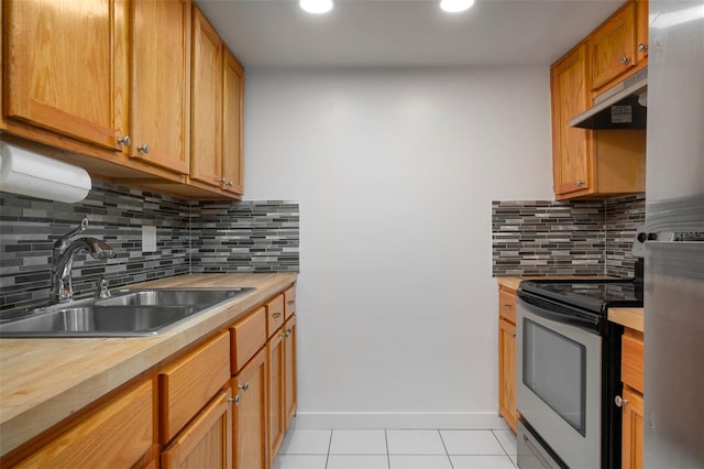 kitchen with exhaust hood, sink, light tile patterned floors, tasteful backsplash, and electric range oven