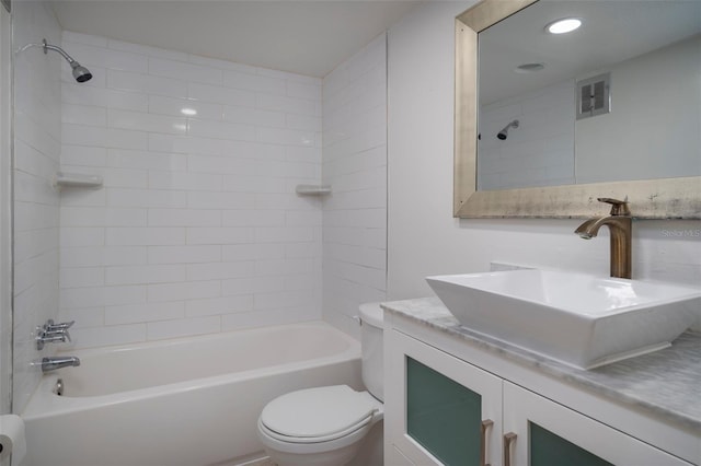 full bathroom featuring vanity, toilet, and tiled shower / bath combo