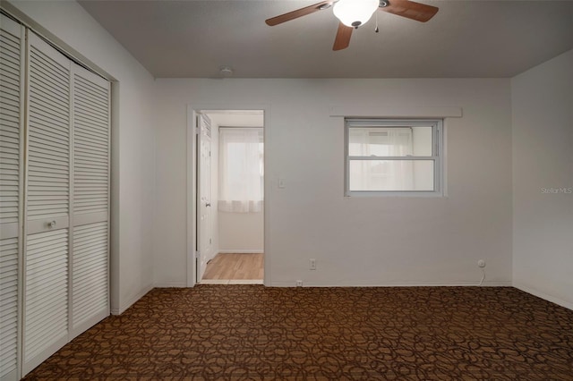 unfurnished bedroom with ceiling fan, light carpet, and a closet