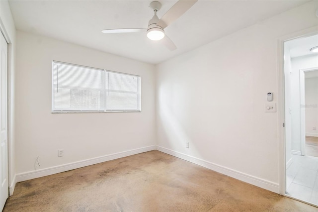 spare room with ceiling fan and light colored carpet