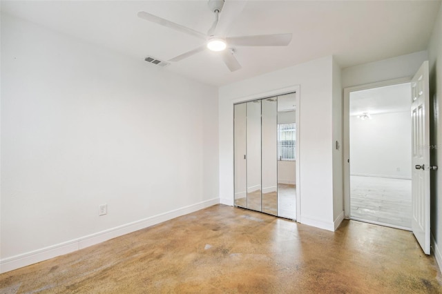 unfurnished bedroom with ceiling fan, a closet, and concrete floors