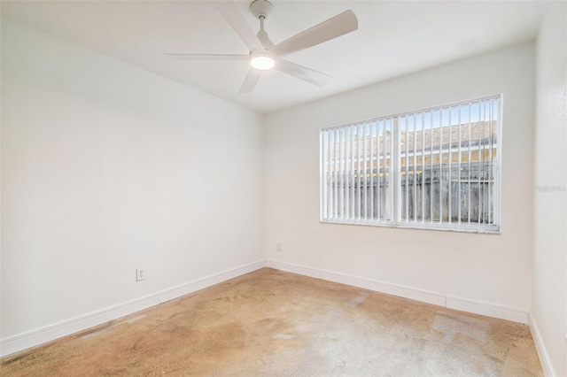 spare room featuring carpet flooring and ceiling fan