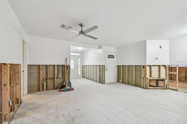 empty room with ceiling fan and light hardwood / wood-style floors