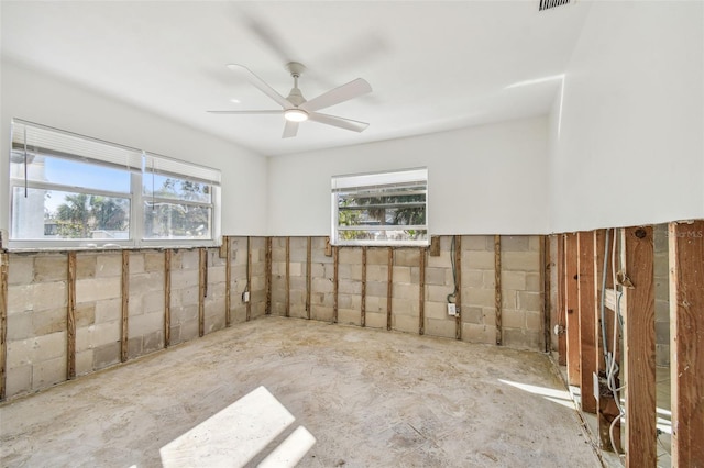 spare room featuring plenty of natural light and ceiling fan