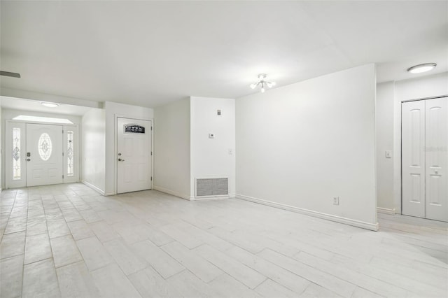 entrance foyer featuring an inviting chandelier and light wood-type flooring