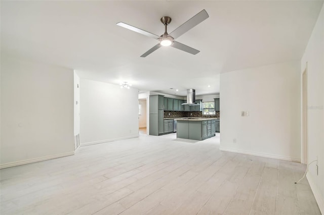 unfurnished living room featuring light wood-type flooring and ceiling fan