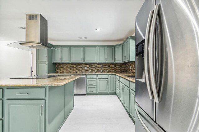 kitchen featuring light stone counters, green cabinets, island exhaust hood, and stainless steel appliances