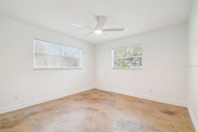 spare room featuring ceiling fan and carpet floors