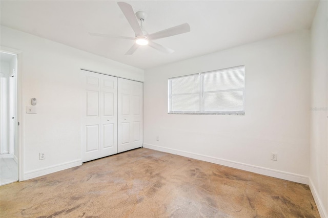 unfurnished bedroom with light carpet, a closet, and ceiling fan