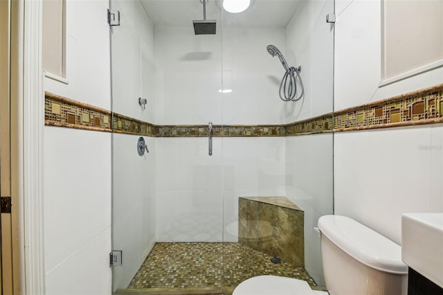 bathroom featuring an enclosed shower, vanity, toilet, and tile walls