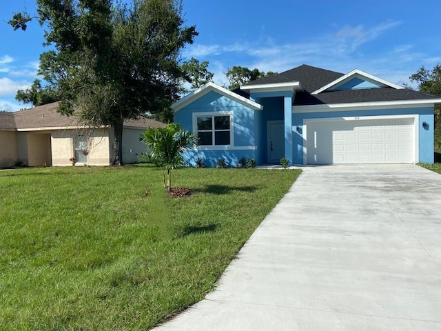 ranch-style house featuring a garage and a front lawn