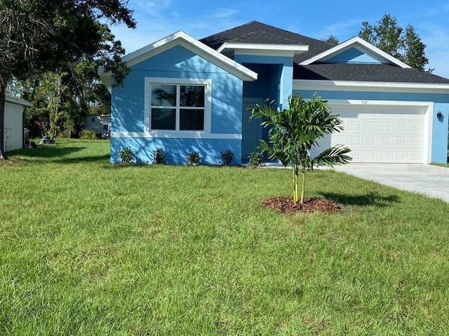 view of front of property with a garage and a front yard