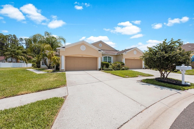 view of front of home featuring a garage and a front lawn