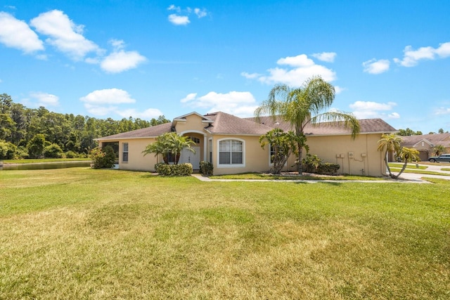 rear view of property featuring a yard