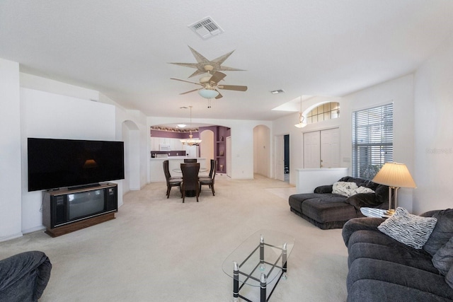 carpeted living room with ceiling fan