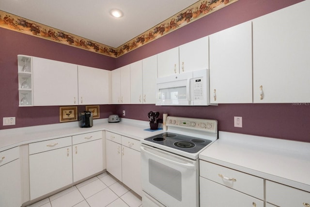 kitchen featuring white cabinets, white appliances, and light tile floors