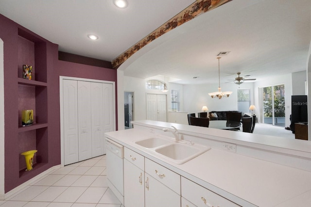 kitchen featuring light tile flooring, ceiling fan, white cabinets, sink, and pendant lighting