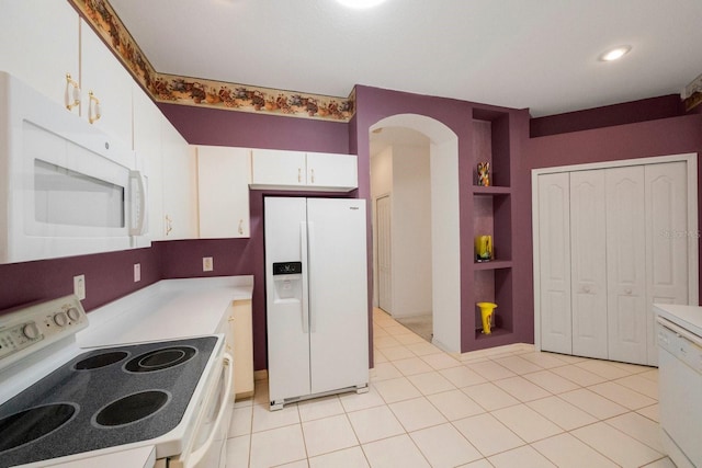 kitchen with white cabinets, built in features, white appliances, and light tile flooring