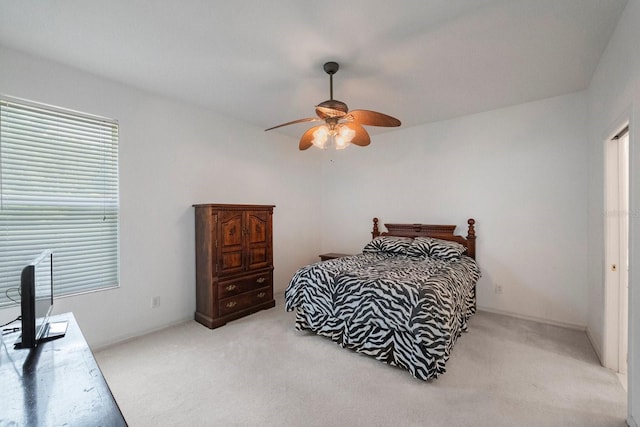 bedroom with light carpet and ceiling fan