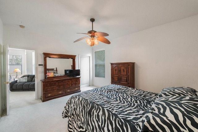 bedroom featuring ceiling fan and light carpet