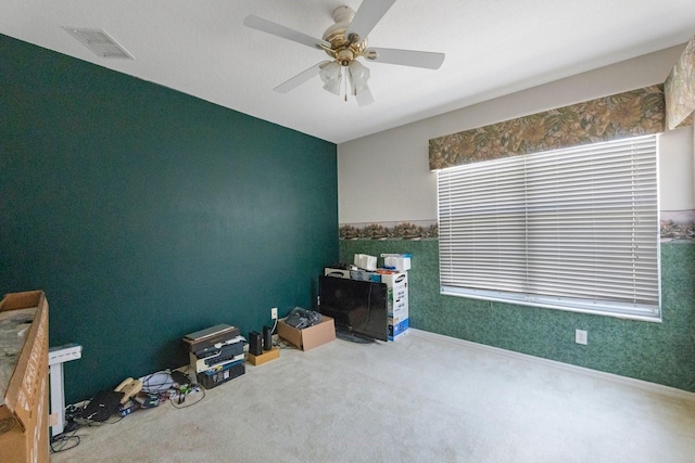 misc room with carpet and ceiling fan