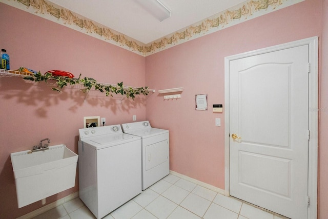 washroom with sink, washer and dryer, washer hookup, and light tile floors