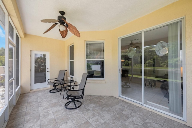 sunroom / solarium featuring ceiling fan