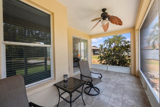 sunroom / solarium featuring ceiling fan