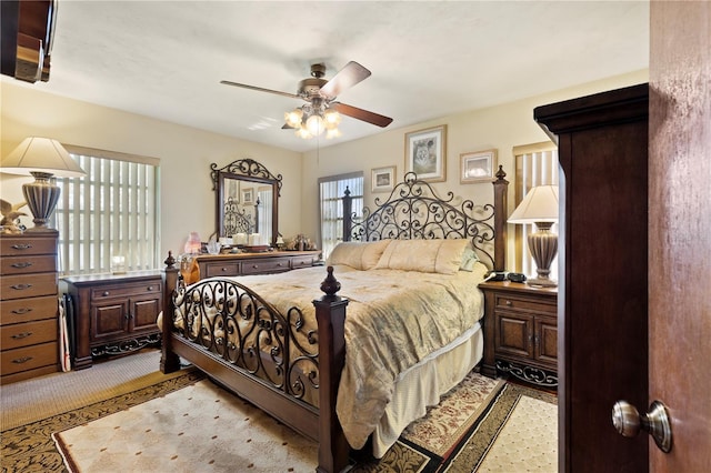 bedroom with ceiling fan and light colored carpet