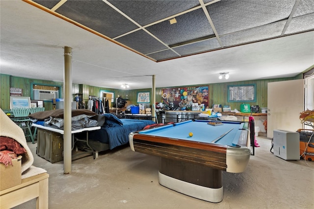 game room featuring a wall unit AC, concrete floors, a textured ceiling, and pool table