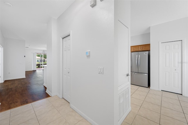 hall featuring light tile floors