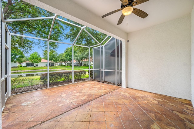 unfurnished sunroom with ceiling fan